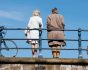 Allianz Trade pension survey cover, old man and young woman on bridge with bicycles